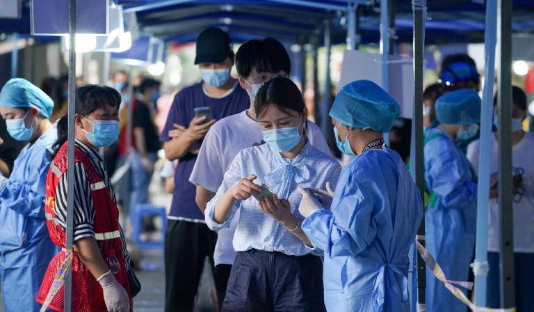 Residents register their details at a Covid-19 test site in Nanjing