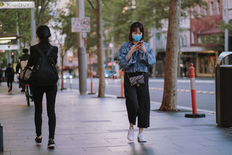 woman in face mask walking down