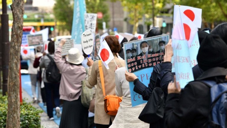 Many slogans appeared to bring up financial issues around Mr Komuro's family - specifically his mother